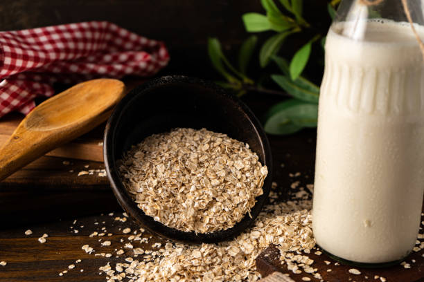 istock Overturned bowl with oatmeal next to a bottle on a kitchen table. Chopped sight. 1359398431