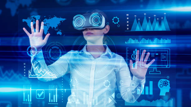 istock Woman looking and touching data analysis screen with virtual reality glasses.View of a young businesswoman using Graphical User Interface with VR glasses. She’s working on a new project. She looks very busy. Blue hologram. Analytics. 1359401840