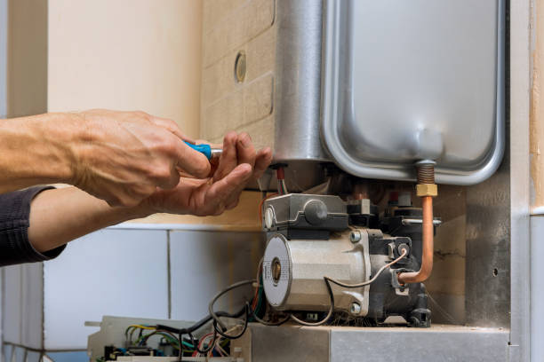 istock Tehnic fix the problem servicing with residential heating equipment on gas boiler for hot water and heating 1359402009