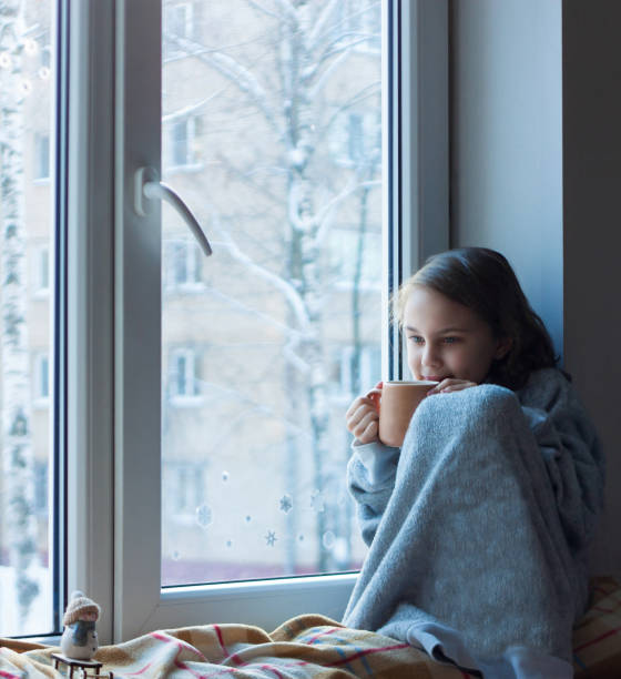 istock The girl raised the mug to her lips 1359402984
