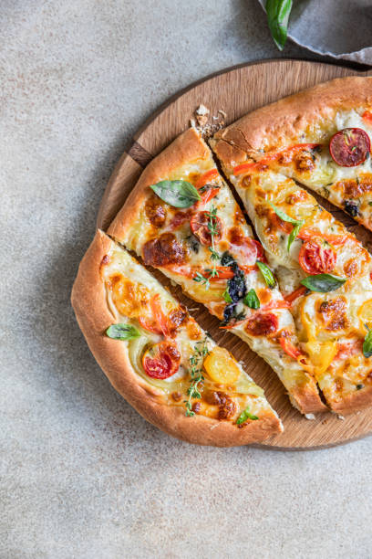 istock Pinsa with vegetables and cheese, concrete background. Traditional rome pizza. Top view. 1359403238