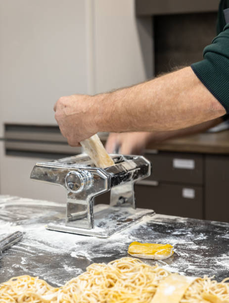 istock The process of making homemade pasta using a pasta machine. The image can be an illustration of the process of making pasta at home or in a culinary master class. 1359404046