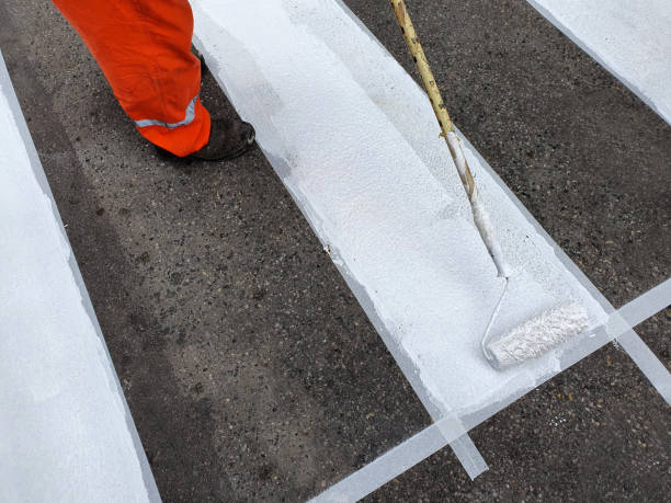 Painting the crosswalk on the street Tape sets the limits of the range freshly painted road markings stock pictures, royalty-free photos & images