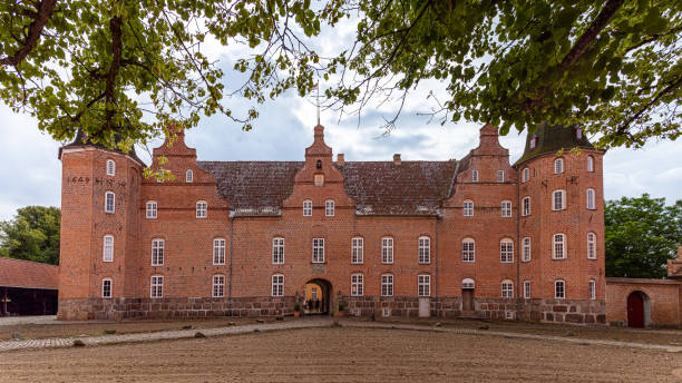 the danish Holsteinborg Castle and courtyard under green beech branches stock photo