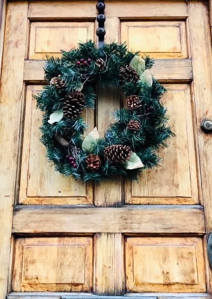 istock Wooden Door With Evergreen & Pine Cone Wreath 1359405316