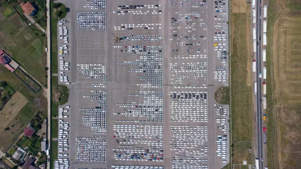 Photo of Empty parking lots, aerial view. A lot of cars in the parking lot. Colorful moody drone shoot.