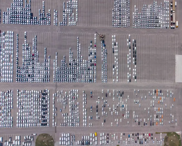 Photo of Empty parking lots, aerial view. A lot of cars in the parking lot. Colorful moody drone shoot.