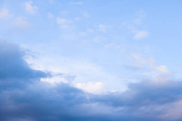 istock Dark rain clouds against a blue sky background 1359407546