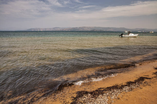 Seascape of south coast of Corfu island with anchored boats, Greece.