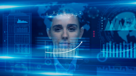 Front view of a businesswoman. She is analyzing the results of the financial position of the company in the third quarter. She has a blank expression on her face. There is a touching screen in front of her. She is looking at holograms. She is wearing a suit.