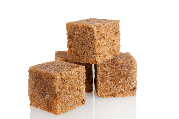 istock Brown dark sugar produced from cane, refined cubes, isolated on a white 1359409427