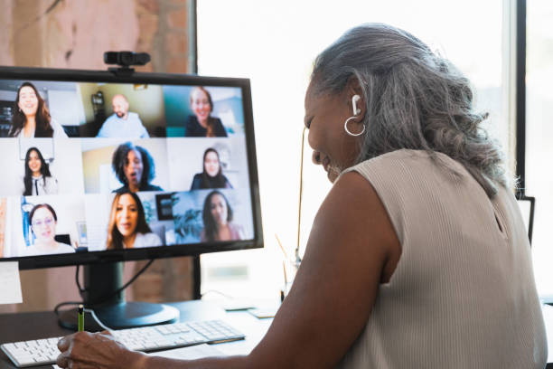 istock Female senior adult student takes notes during online class 1359410928