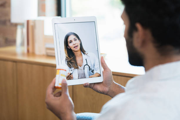 istock Mid adult man listens to virtual doctor's advice about medication 1359410941