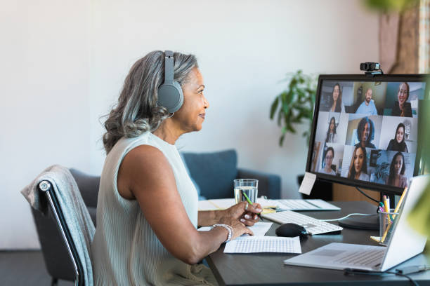 istock Senior CEO leads meeting with employees from home 1359410979