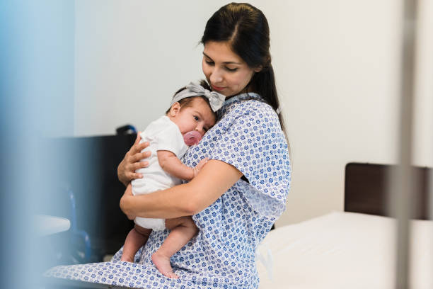 istock Mother comforts baby while waiting to see emergency room doctor 1359412007