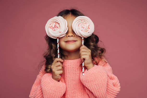 istock Cute little girl with lollipop 1359413947