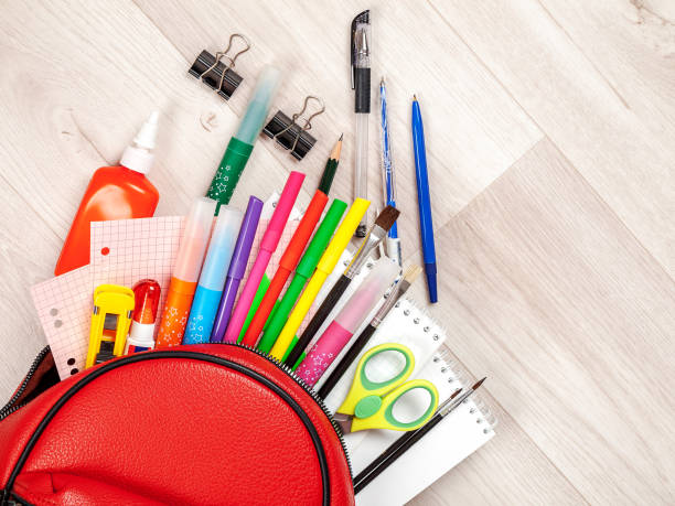 istock School student supplies for teaching, studying, scattered from the school bag backpack, new school 1359414080