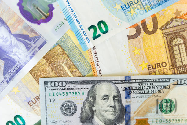istock close up of a dollars and euro. Background from different banknotes 1359414781