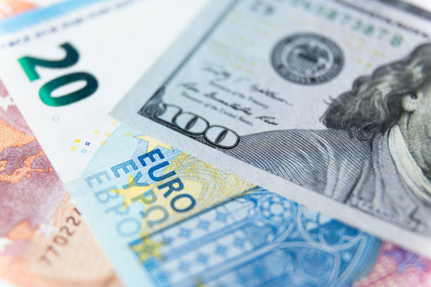 istock close up of a dollars and euro. Background from different banknotes 1359414783