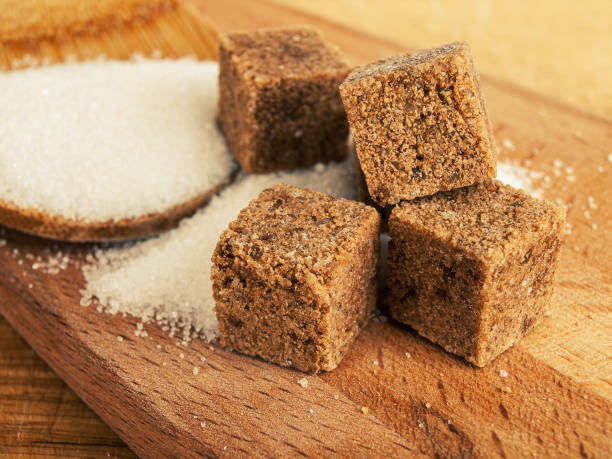 istock Dark sugar in cubes and white crystalline sugar, refined sugar, the difference between cane and beet sugar 1359416110