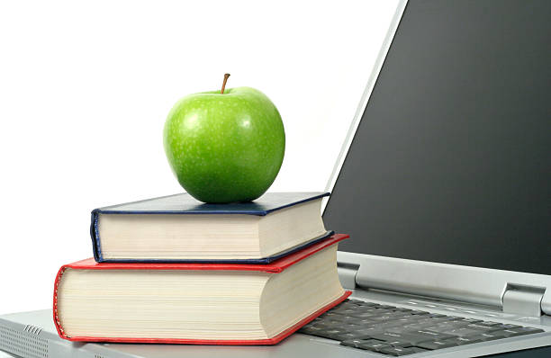 istock Apple with books and laptop 135941735
