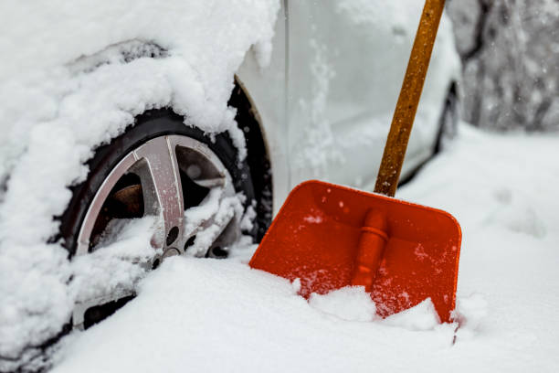 Winter tire. Detail of car tires in winter on the road covered with snow. Winter driving conditions. Snow storm, snow tires,driving hazards and weather concept. car snow stock pictures, royalty-free photos & images