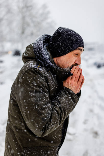 istock Man blowing his nose in the cold weather 1359419531