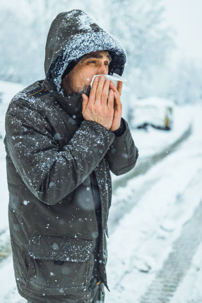 istock Man blowing his nose in the cold weather 1359419541