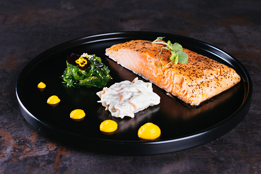 Salmon Steak with Butter Toast Ready to eat on a wooden table.