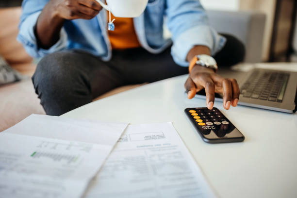 istock Close up of an unrecognisable man going over finances at home office 1359420214