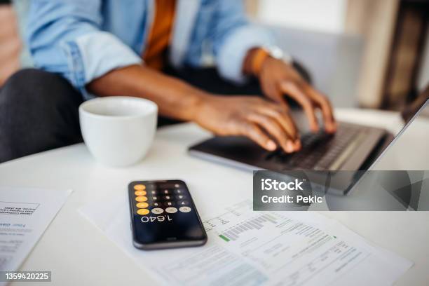 Close Up Of An Unrecognisable Man Going Over Finances At Home Office Stock Photo - Download Image Now