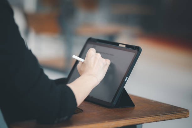 istock A female teacher with a tablet sits in an empty classroom at the university. while waiting to teach the students at the class 1359421819