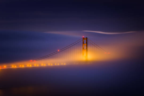 she rests - foggy golden gate bridge - golden gate bridge san francisco county fog travel destinations - fotografias e filmes do acervo