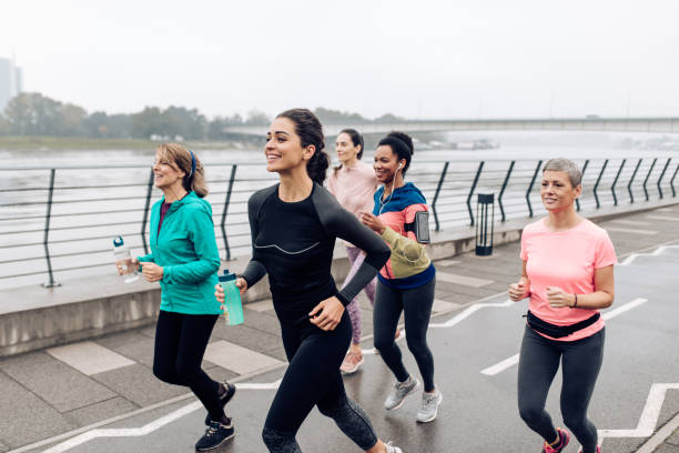 istock Group of women running on the rain 1359424347