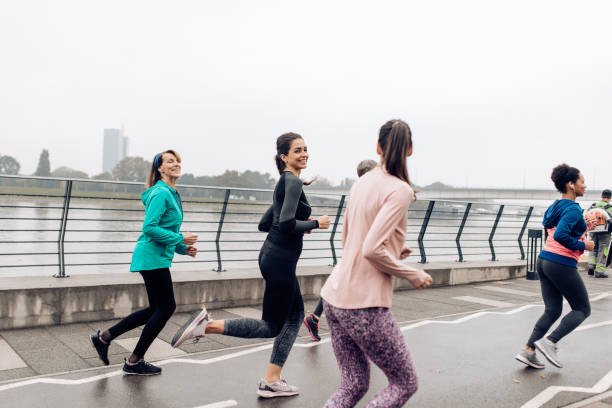 istock Female running team training on a rainy day 1359424354