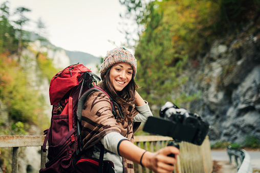 Young Female Vlogger In The Nature Holding A Camera