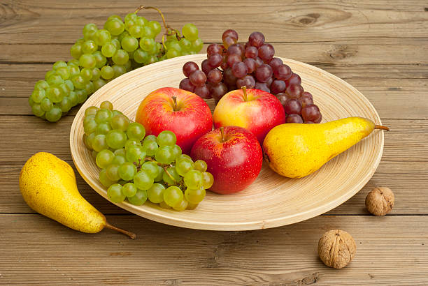 istock Fruits on wooden dish 135943265