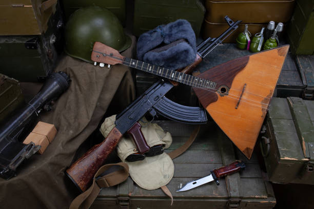 istock Kalashnikov AK 47 with ammunition and balalaika on army boxes background 1359432909