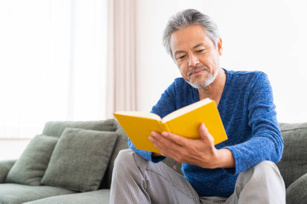 istock elderly man who reads a book, 1359435275