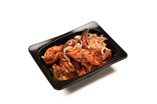 istock Tandoori Chicken in Disposable Container Isolated on White Background 1359435352