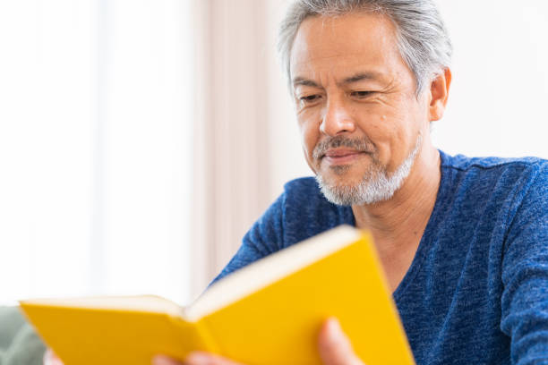 istock elderly man who reads a book, 1359435409