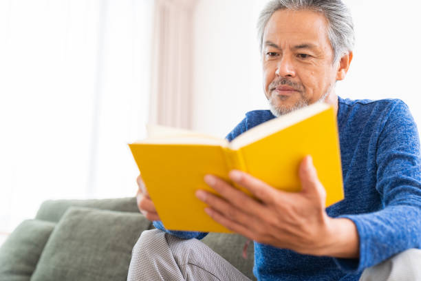 istock elderly man who reads a book, 1359435417