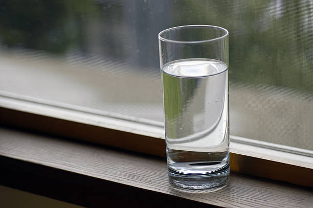 Glass of Water by window stock photo