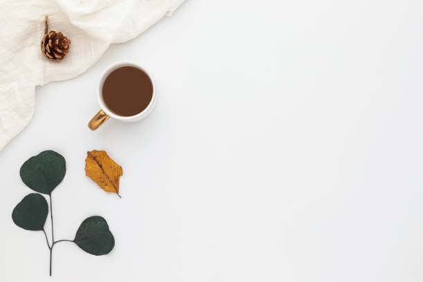 istock Autumn composition, coffee cup. dried leaves. and pine cones on white background. Flat lay, top view with copy space 1359436378