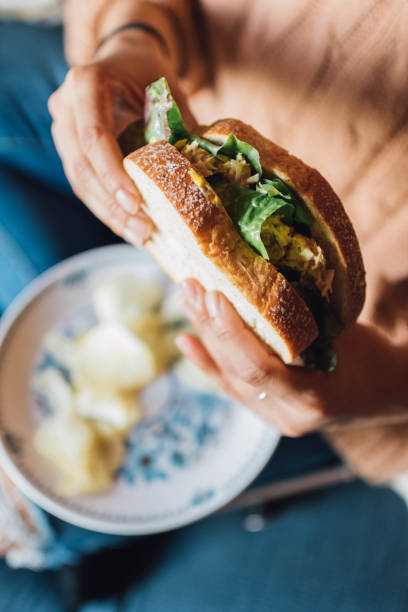 istock hands holding tuna salad sandwich 1359439694