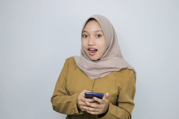 istock Shock government worker women when using a smartphone. PNS wearing khaki uniform. 1359444045