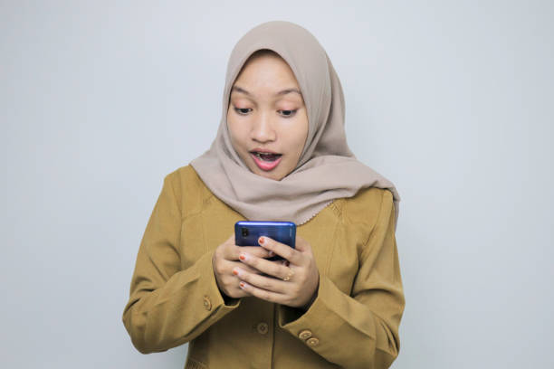 istock Shock government worker women when using a smartphone. PNS wearing khaki uniform. 1359444047