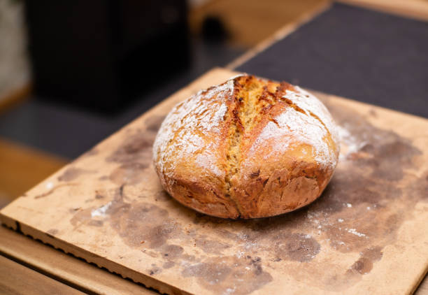 istock Fresh baked sourdough bread on baking stone. 1359452362