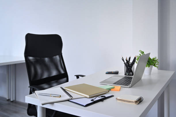 istock Home office interior. Mockup computer laptop and supplies on white table with comfortable office chair. 1359455416