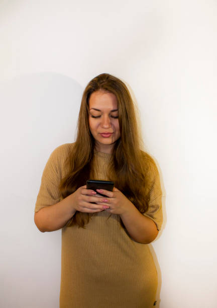 istock young beautiful woman with a smartphone, writes a message, makes a selfie, communicates 1359455543